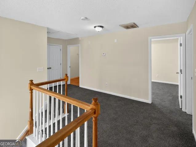 a view of an empty room with stairs