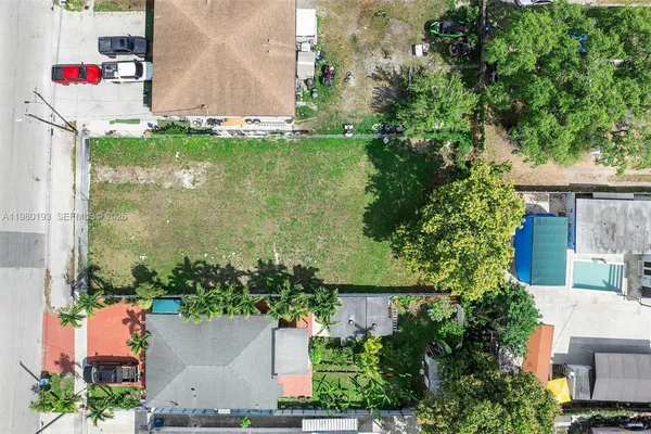 an aerial view of house with yard swimming pool and outdoor seating