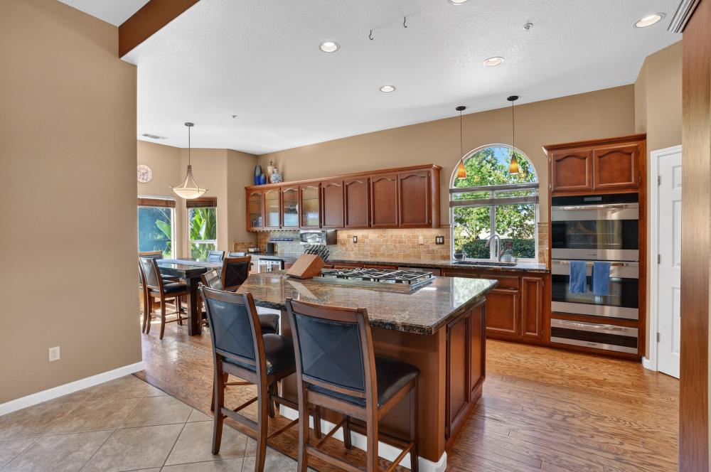 6504 Swallowsview Court Rocklin, CA 95677 - Photo 12 of 66 a kitchen with a stove a refrigerator and a dining table