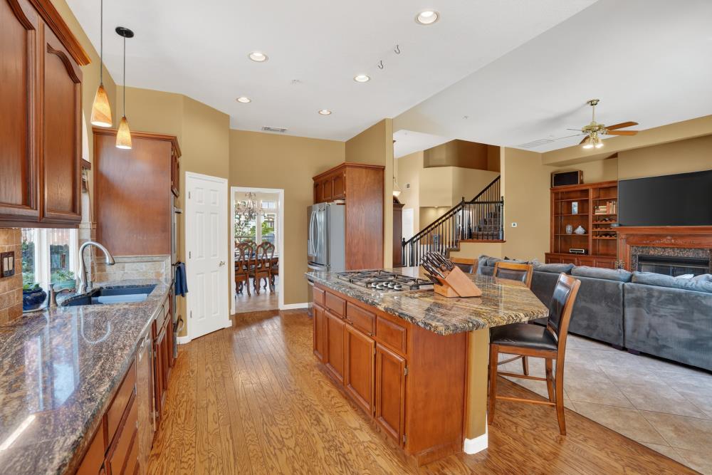 6504 Swallowsview Court Rocklin, CA 95677 - Photo 14 of 66 a kitchen with stainless steel appliances granite countertop counter top space a stove a refrigerator and cabinets