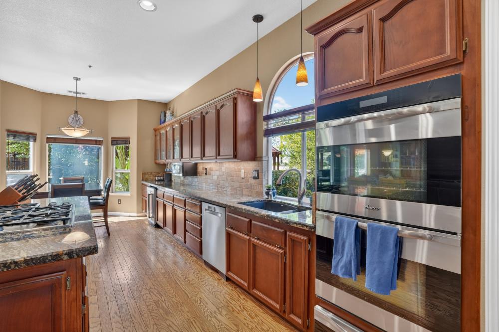 6504 Swallowsview Court Rocklin, CA 95677 - Photo 16 of 66 a kitchen with stainless steel appliances granite countertop a stove and cabinets