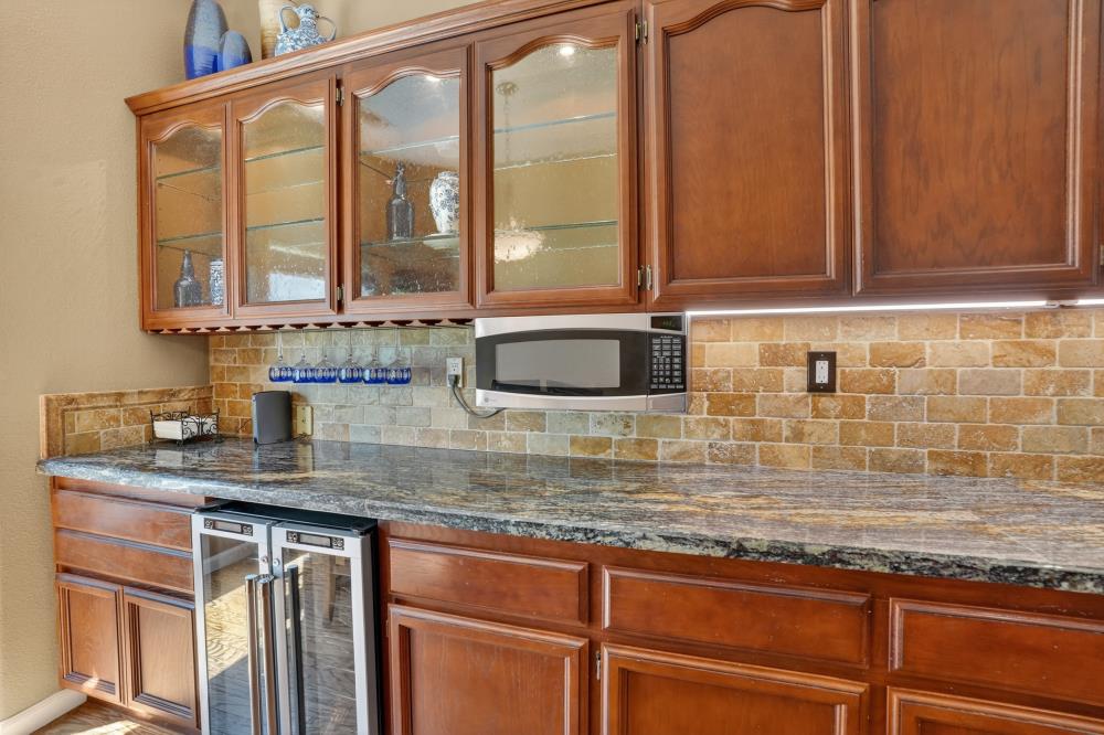 6504 Swallowsview Court Rocklin, CA 95677 - Photo 19 of 66 a kitchen with kitchen island granite countertop a sink and a window