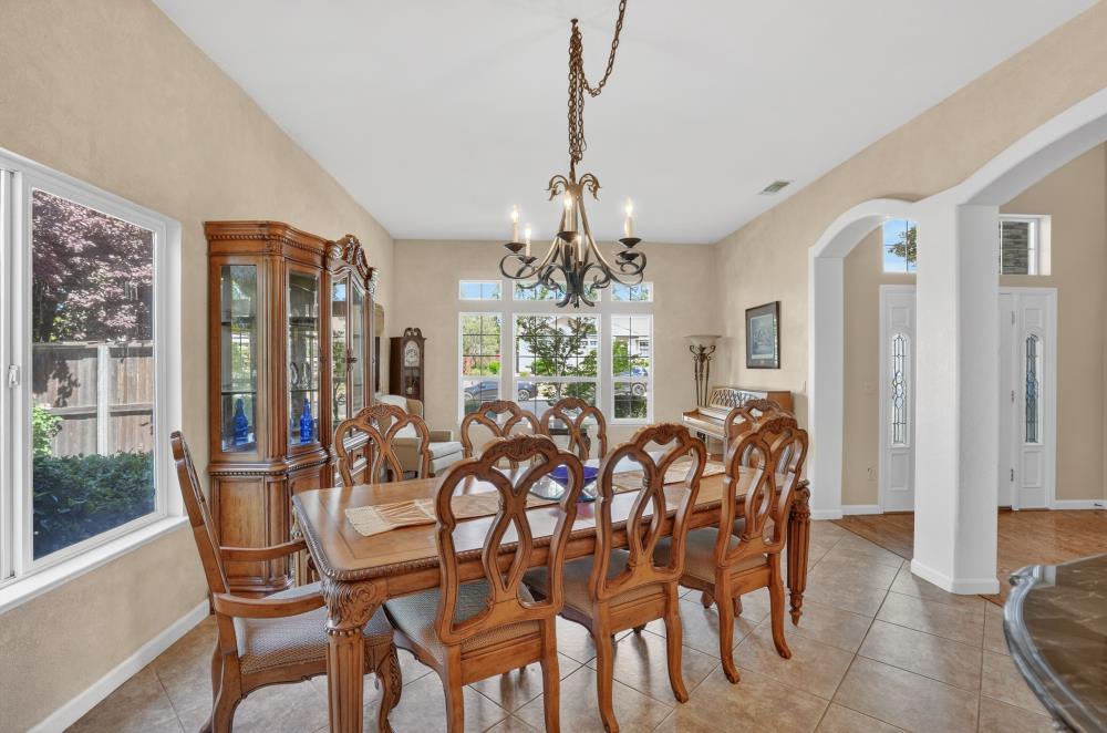 6504 Swallowsview Court Rocklin, CA 95677 - Photo 24 of 66 a view of a dining room with furniture and chandelier
