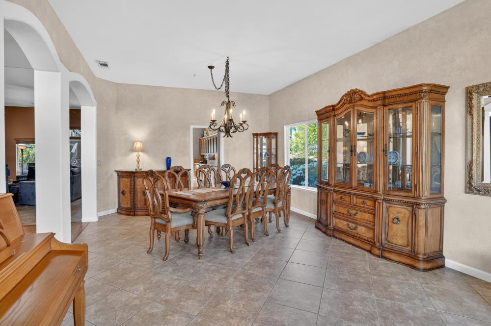 6504 Swallowsview Court Rocklin, CA 95677 - Photo 25 of 66 a dining room with furniture a chandelier and window