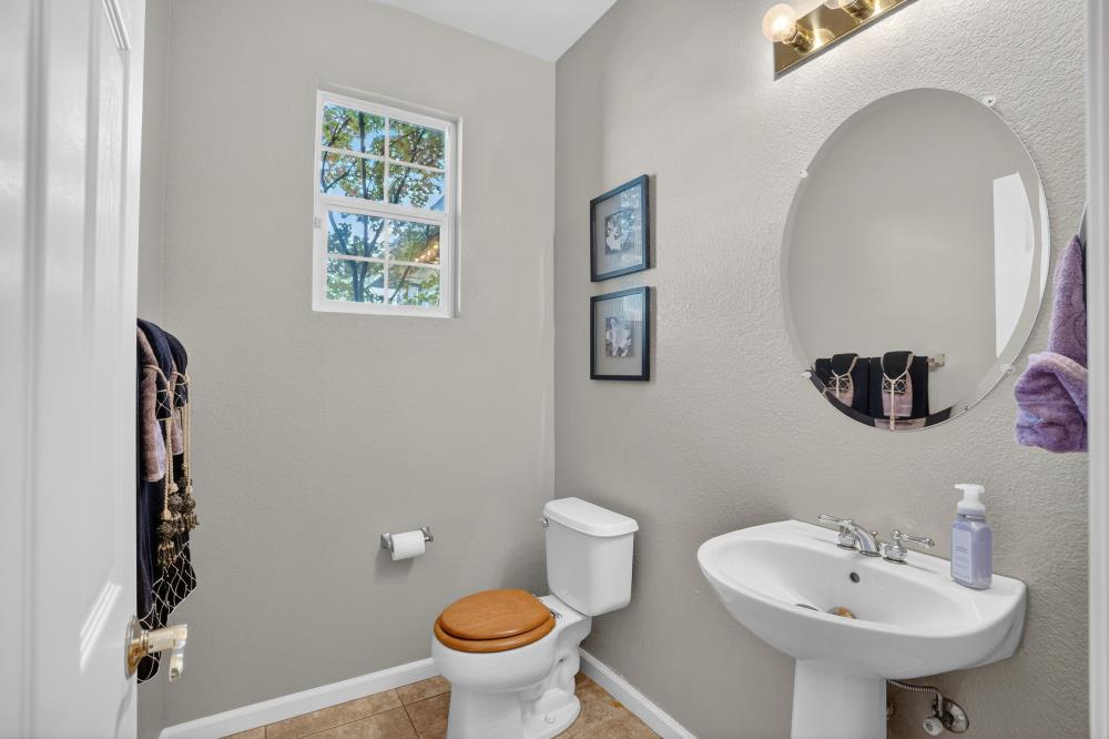 6504 Swallowsview Court Rocklin, CA 95677 - Photo 27 of 66 a bathroom with a sink toilet and a mirror