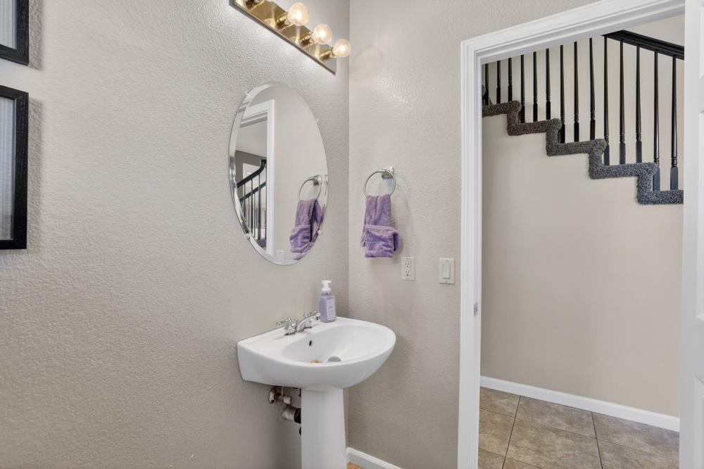 6504 Swallowsview Court Rocklin, CA 95677 - Photo 28 of 66 a bathroom with a sink and mirror