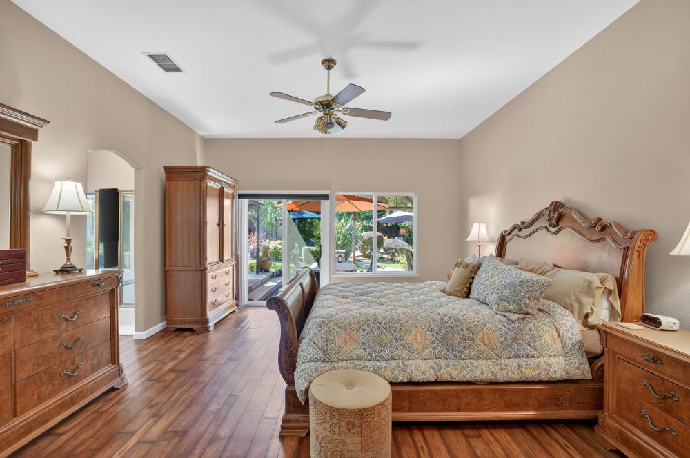 6504 Swallowsview Court Rocklin, CA 95677 - Photo 30 of 66 a bedroom with a bed and wooden floor