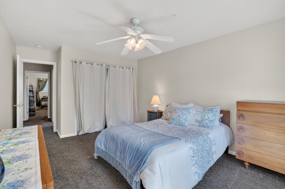 6504 Swallowsview Court Rocklin, CA 95677 - Photo 43 of 66 a bedroom with a bed and a chandelier