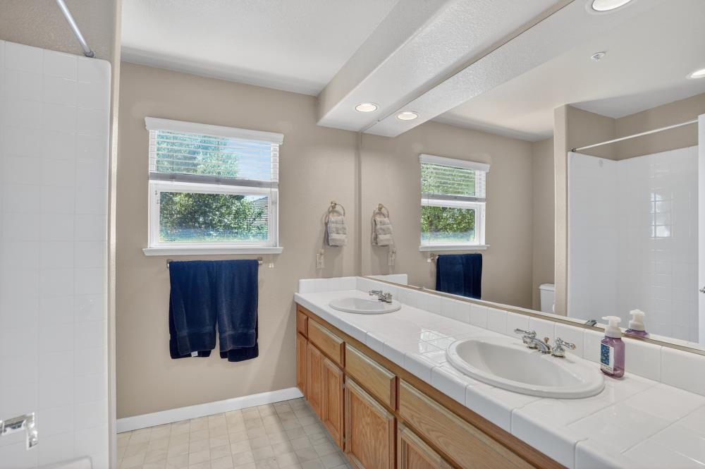 6504 Swallowsview Court Rocklin, CA 95677 - Photo 47 of 66 a bathroom with a sink and a mirror