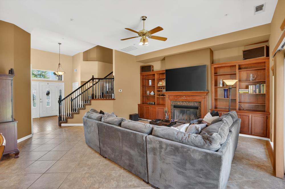 6504 Swallowsview Court Rocklin, CA 95677 - Photo 10 of 66 a living room with fireplace furniture and a flat screen tv