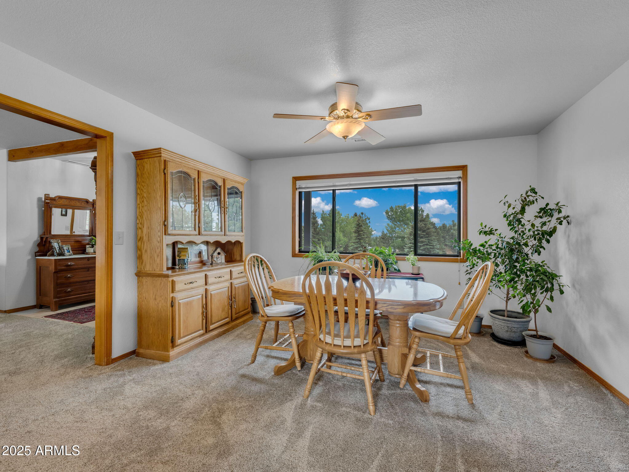 5545 East Atkinson Road Flagstaff, AZ 86004 - Photo 12 of 55 a dining room with furniture and a floor to ceiling window
