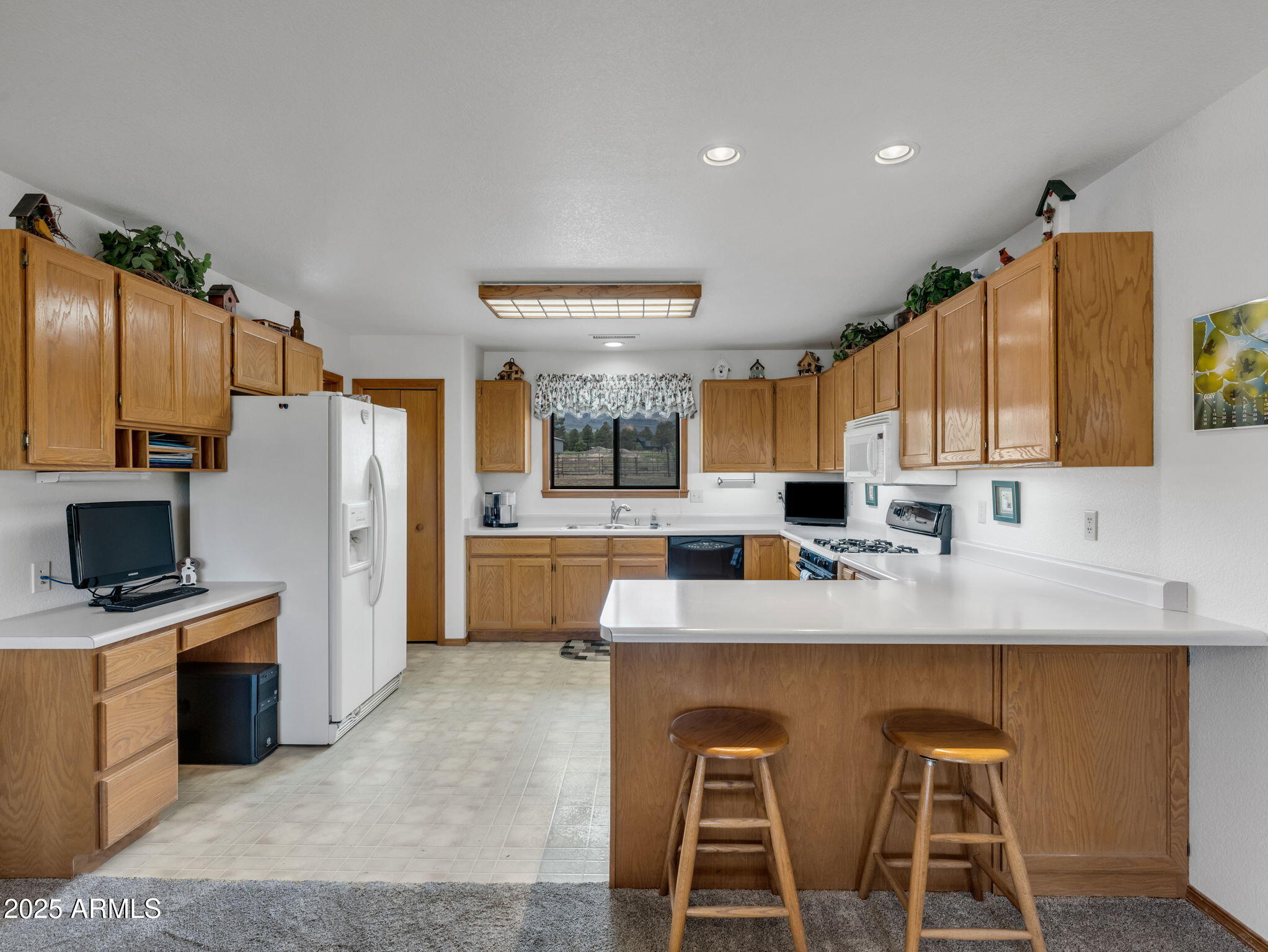 5545 East Atkinson Road Flagstaff, AZ 86004 - Photo 14 of 55 a large kitchen with granite countertop a large counter top stainless steel appliances and cabinets
