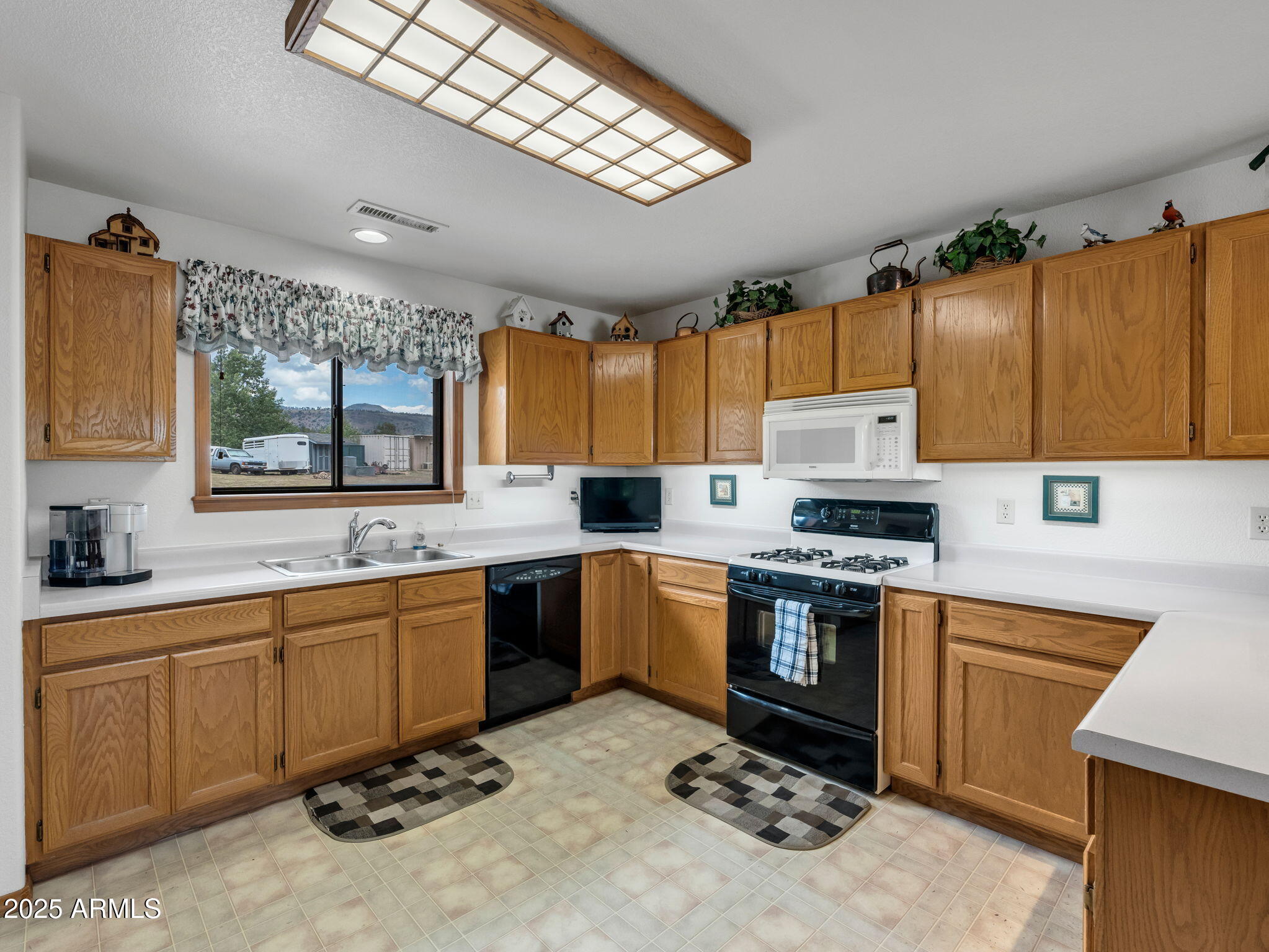 5545 East Atkinson Road Flagstaff, AZ 86004 - Photo 16 of 55 a kitchen with a sink stove and microwave
