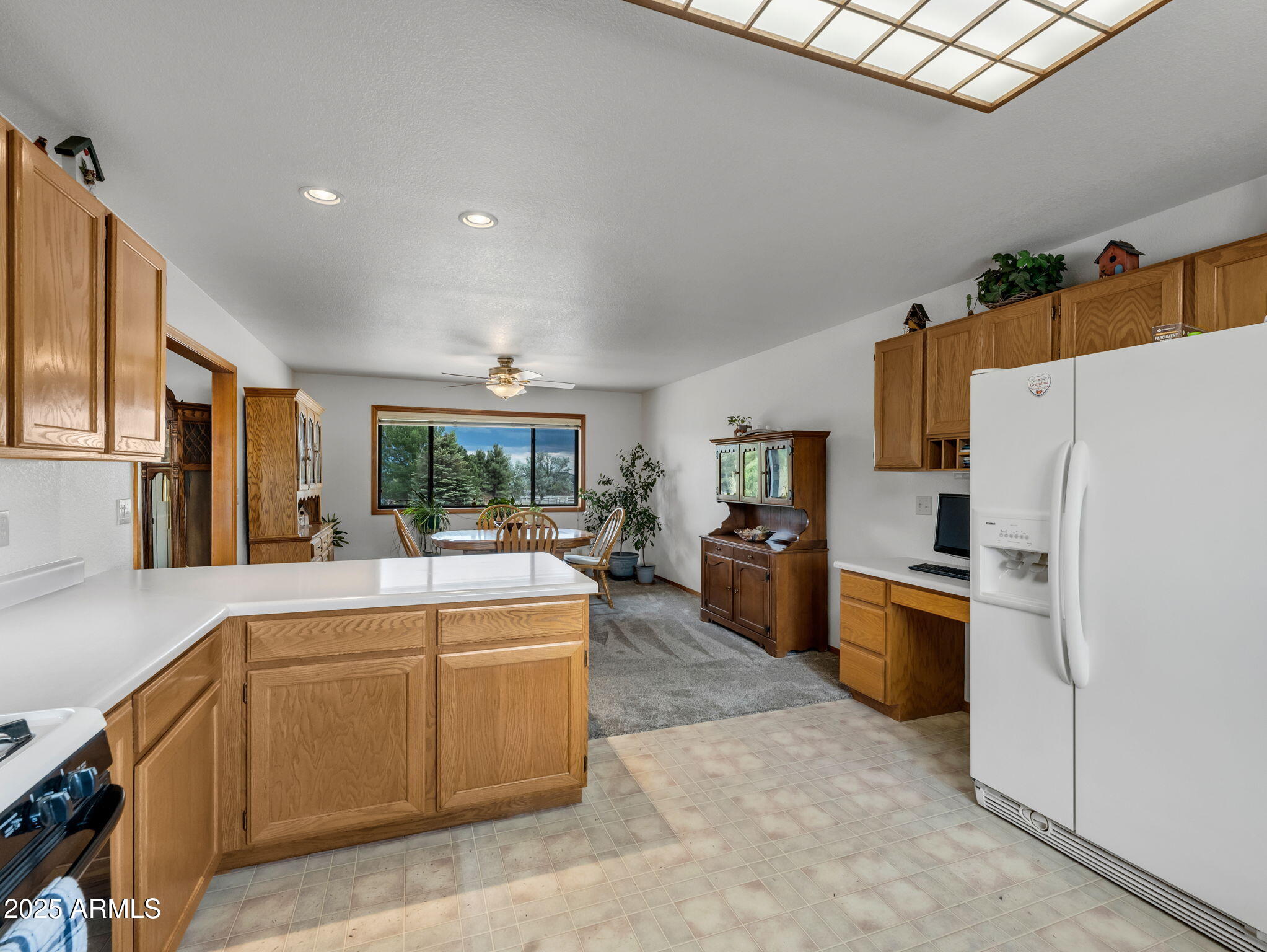 5545 East Atkinson Road Flagstaff, AZ 86004 - Photo 17 of 55 a kitchen with stainless steel appliances a refrigerator a stove a sink a dining table and chairs