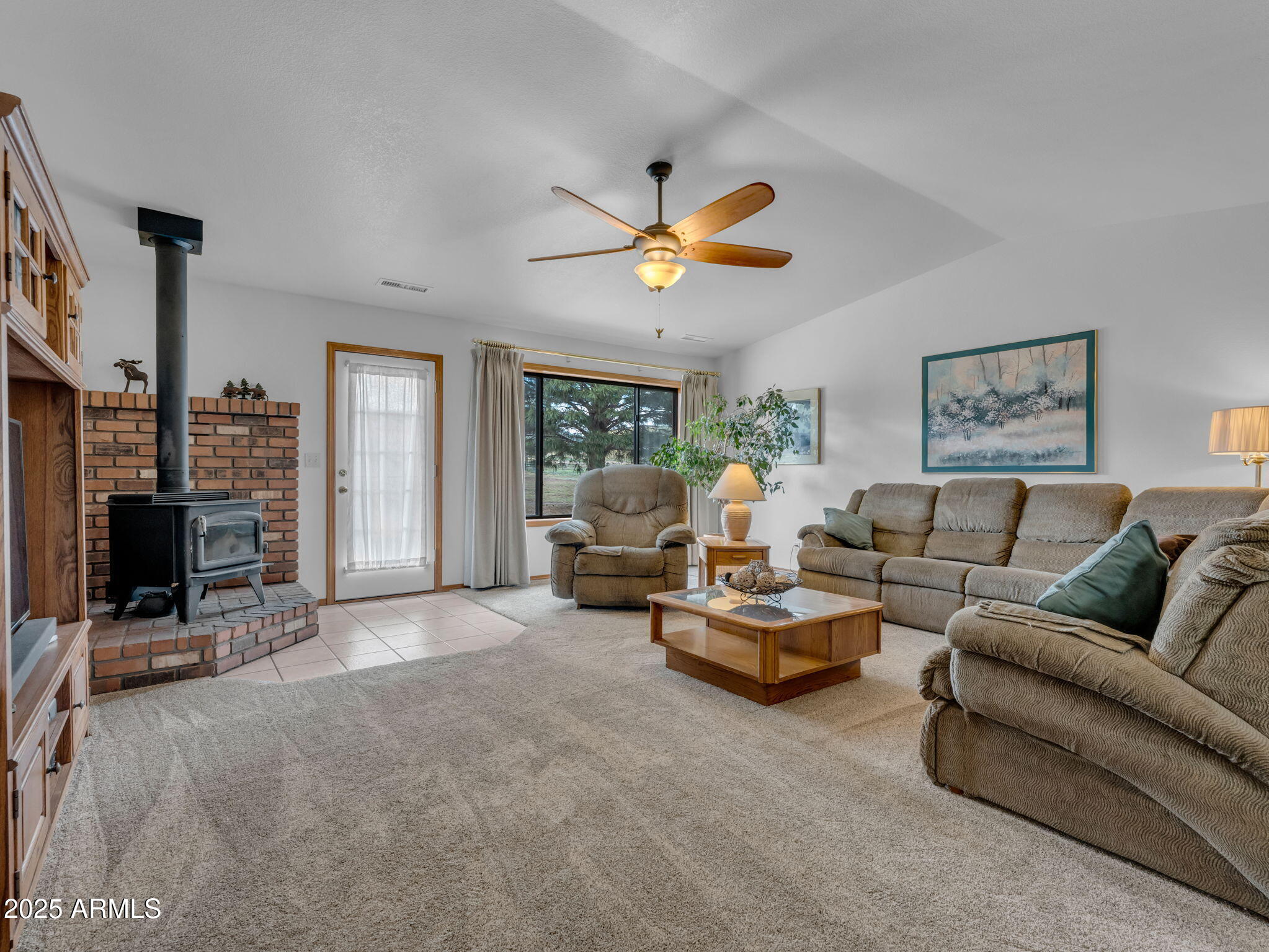 5545 East Atkinson Road Flagstaff, AZ 86004 - Photo 21 of 55 a living room with furniture a fireplace and a flat screen tv