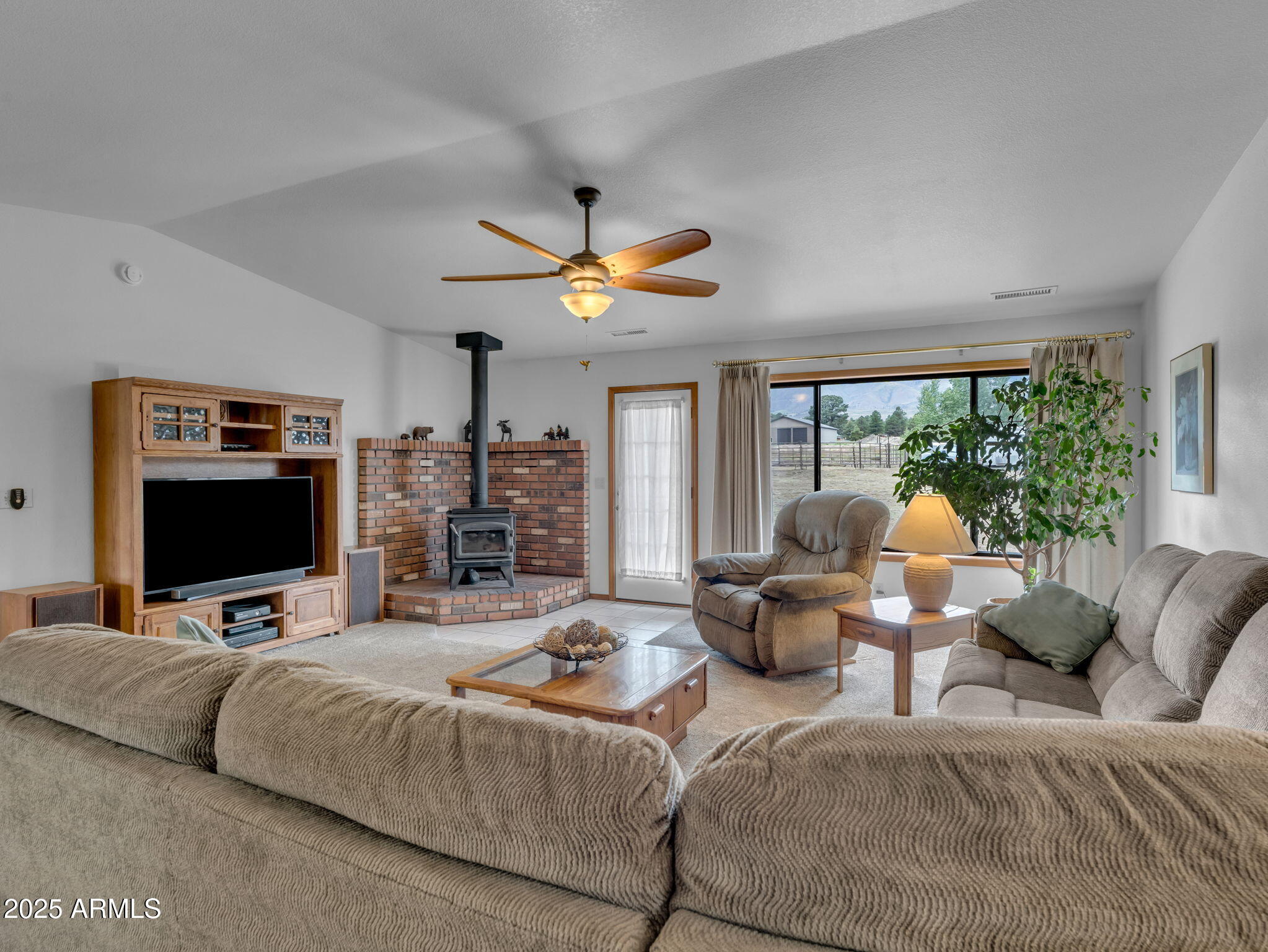 5545 East Atkinson Road Flagstaff, AZ 86004 - Photo 23 of 55 a living room with furniture a large window and a flat screen tv