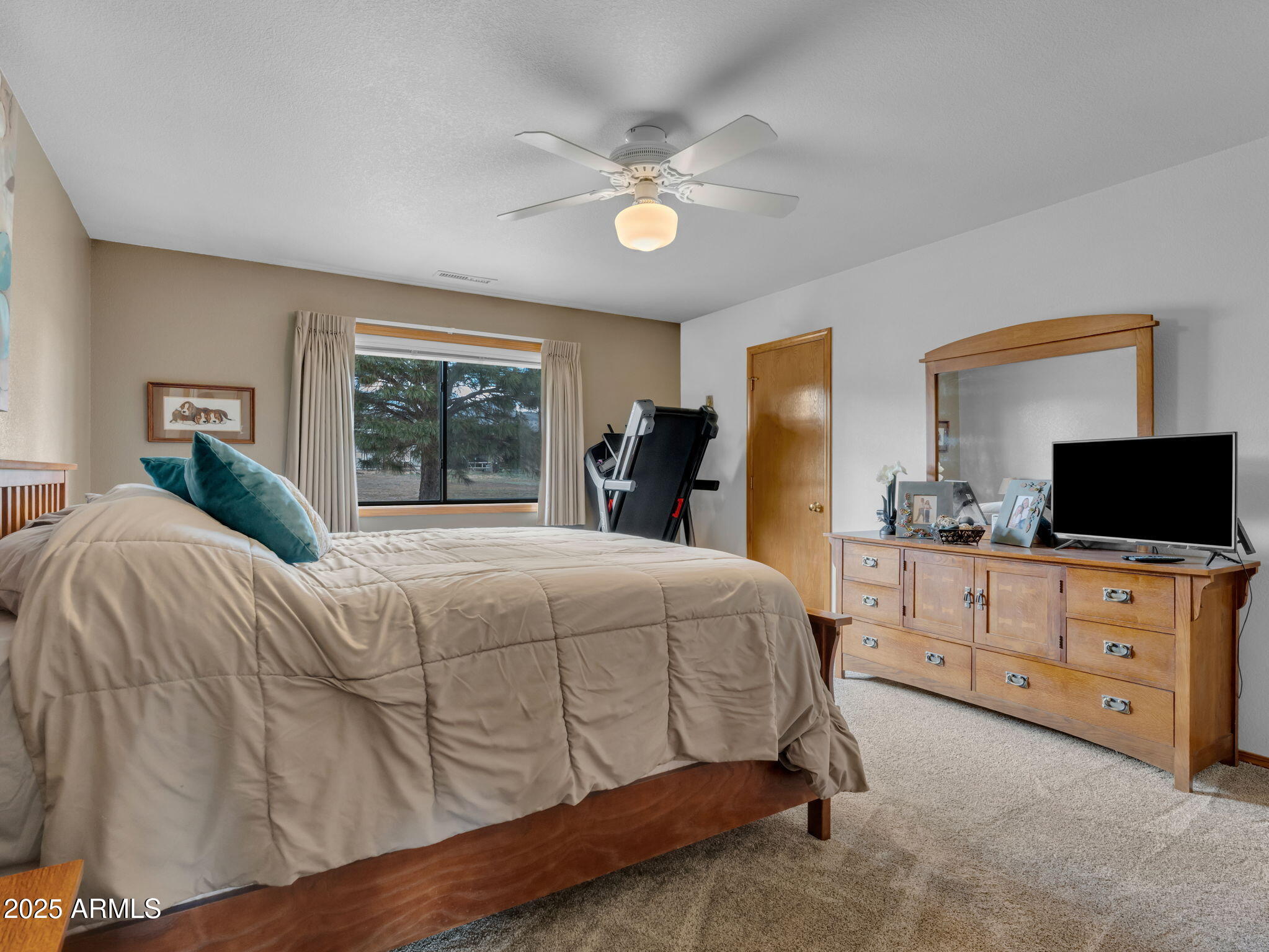5545 East Atkinson Road Flagstaff, AZ 86004 - Photo 24 of 55 a bedroom with a bed and a flat screen tv