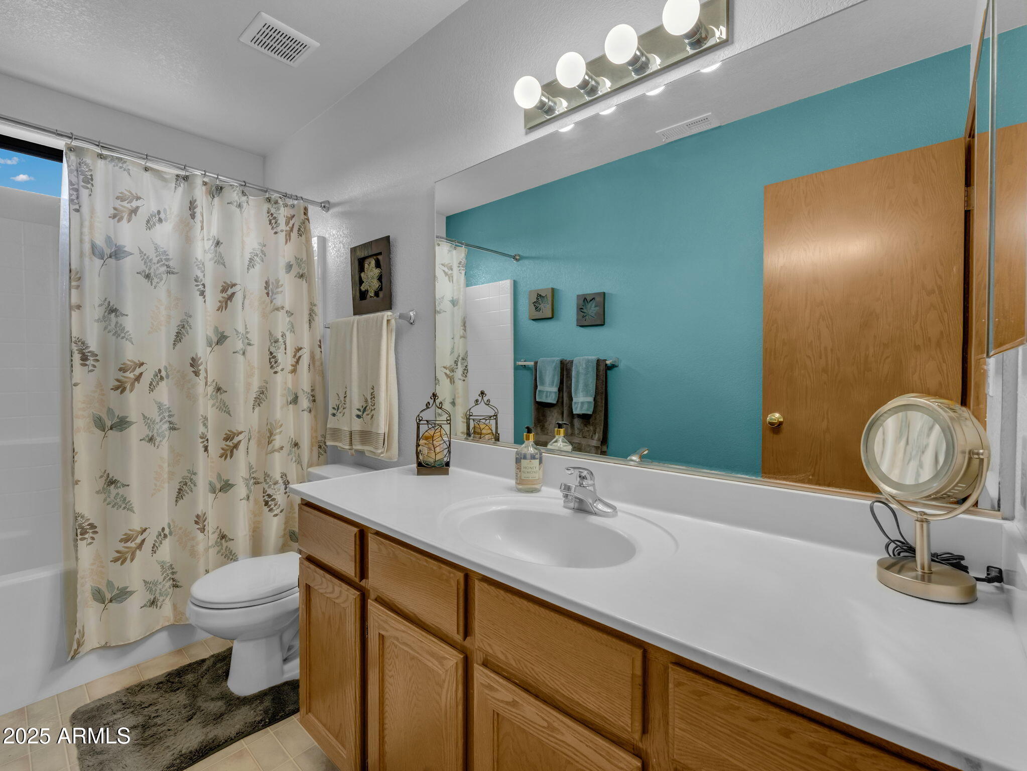 5545 East Atkinson Road Flagstaff, AZ 86004 - Photo 28 of 55 a bathroom with a sink a toilet and shower curtain