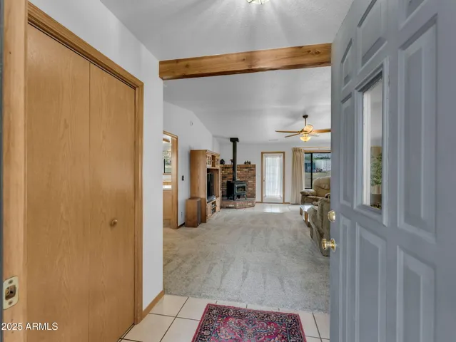 a view of a hallway with bathroom and front door