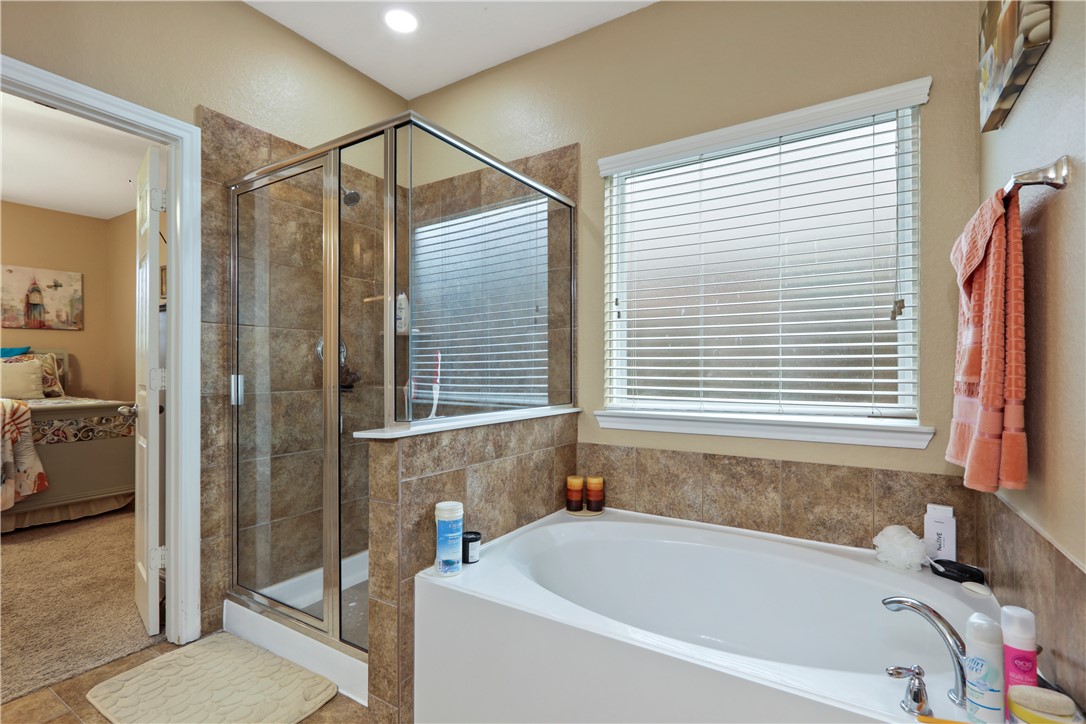 13423 Astley Acres Lane Cypress, TX 77429 - Photo 25 of 39 a bathroom with a bathtub and a shower
