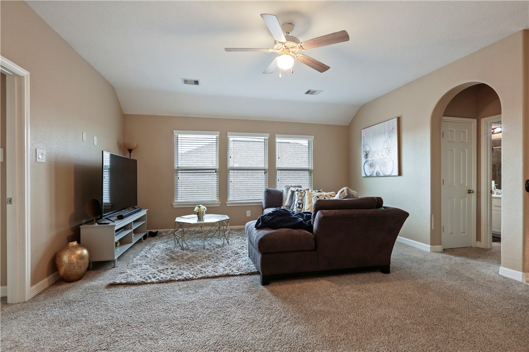 13423 Astley Acres Lane Cypress, TX 77429 - Photo 27 of 39 a living room with furniture a ceiling fan and a flat screen tv