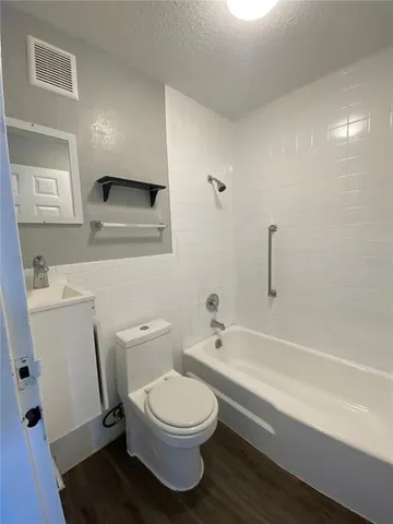 a bathroom with a toilet a sink and bathtub