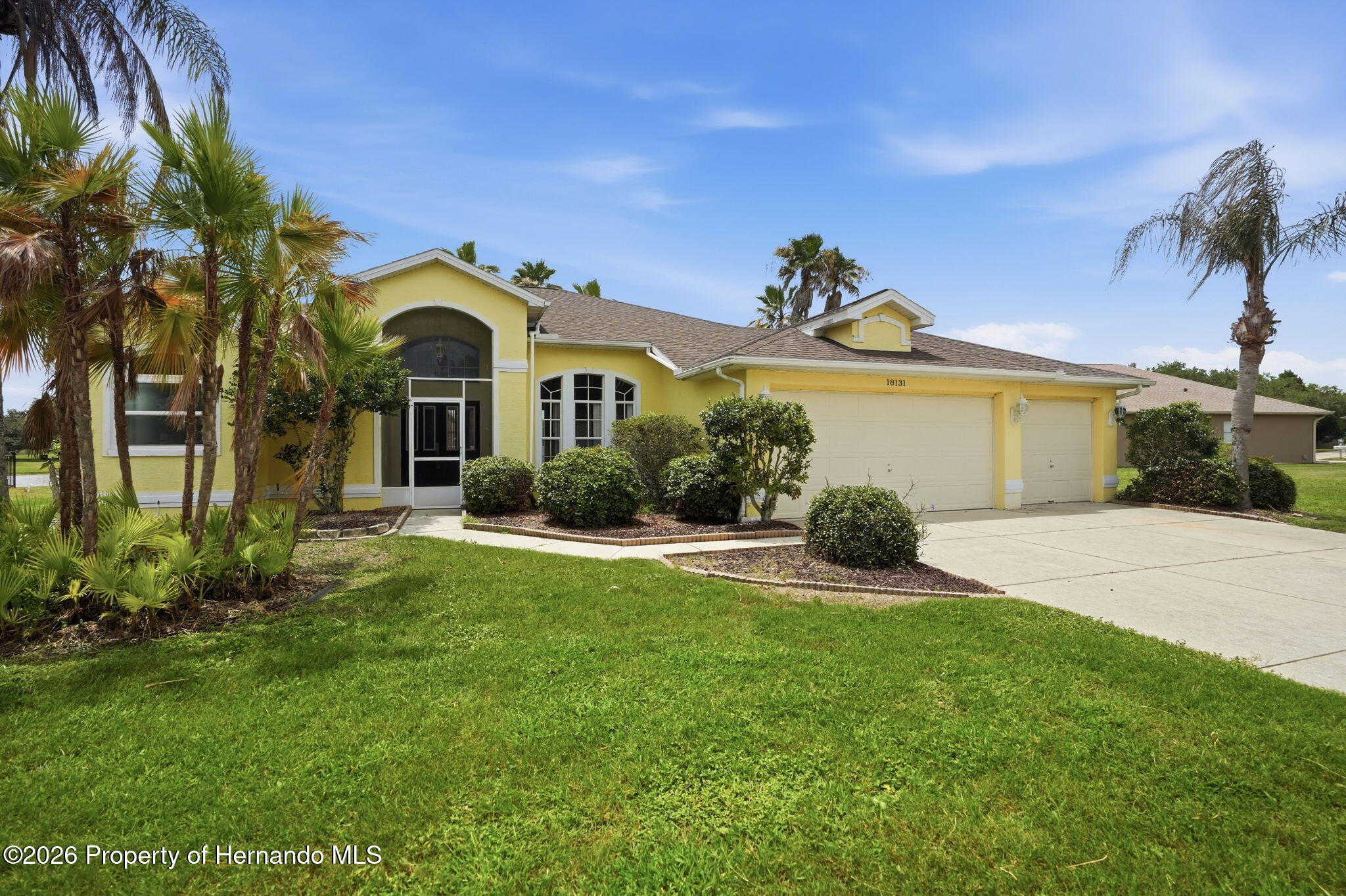 18131 Rivard Boulevard Brooksville, FL 34604 - Photo 2 of 66 a front view of a house with a yard and garage