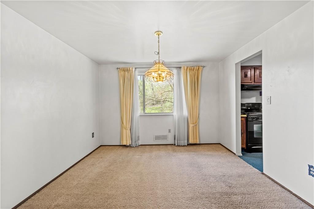 1709 Wilson Road Pittsburgh, PA 15236 - Photo 11 of 25 an empty room with windows and cabinet