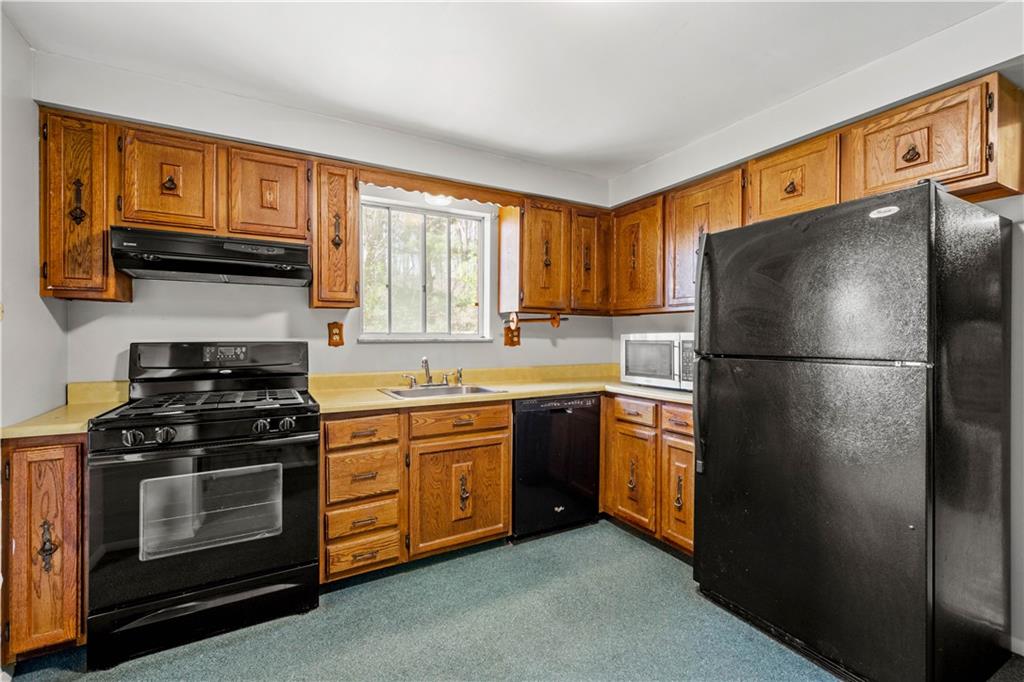 1709 Wilson Road Pittsburgh, PA 15236 - Photo 12 of 25 a kitchen with stainless steel appliances granite countertop a refrigerator stove a sink and a granite counter tops