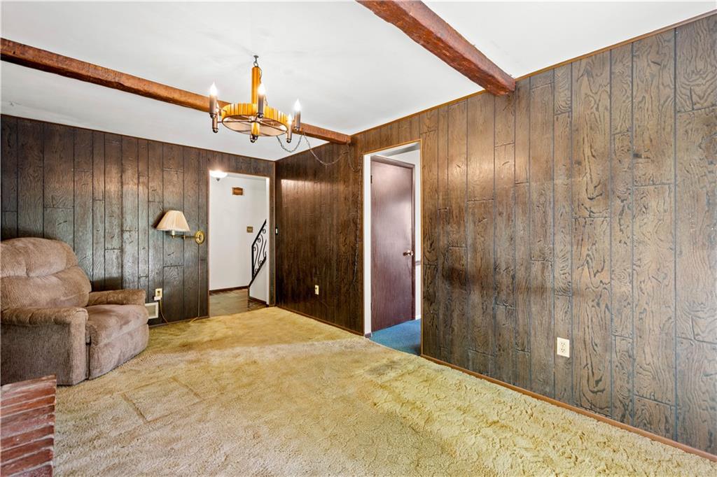 1709 Wilson Road Pittsburgh, PA 15236 - Photo 15 of 25 a bedroom with a bed and a chandelier