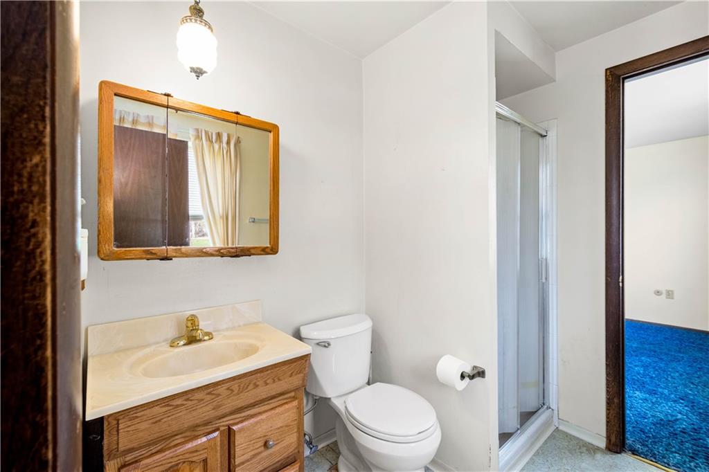 1709 Wilson Road Pittsburgh, PA 15236 - Photo 19 of 25 a bathroom with a granite countertop toilet a sink and a mirror