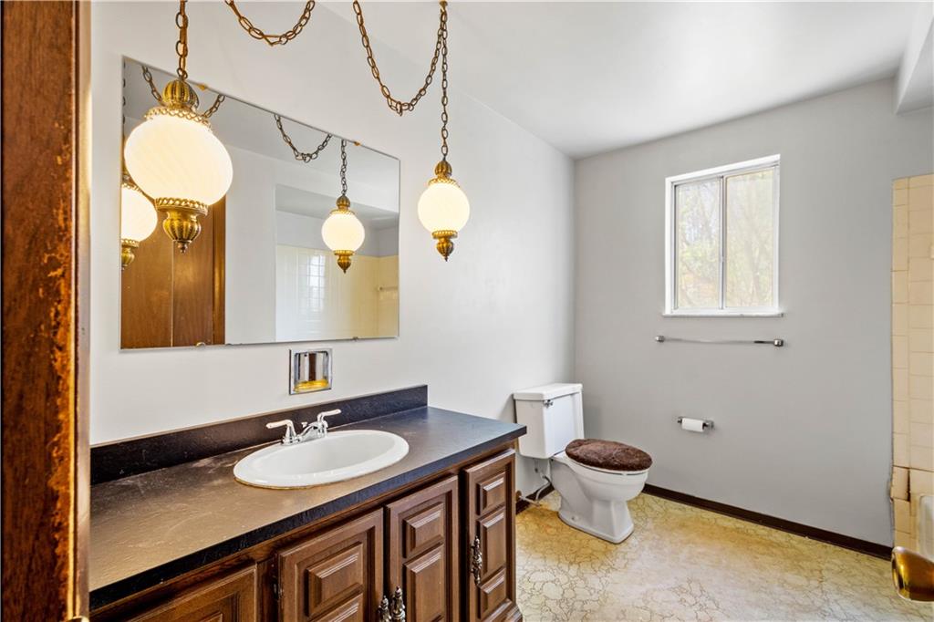 1709 Wilson Road Pittsburgh, PA 15236 - Photo 21 of 25 a bathroom with a sink vanity and a mirror