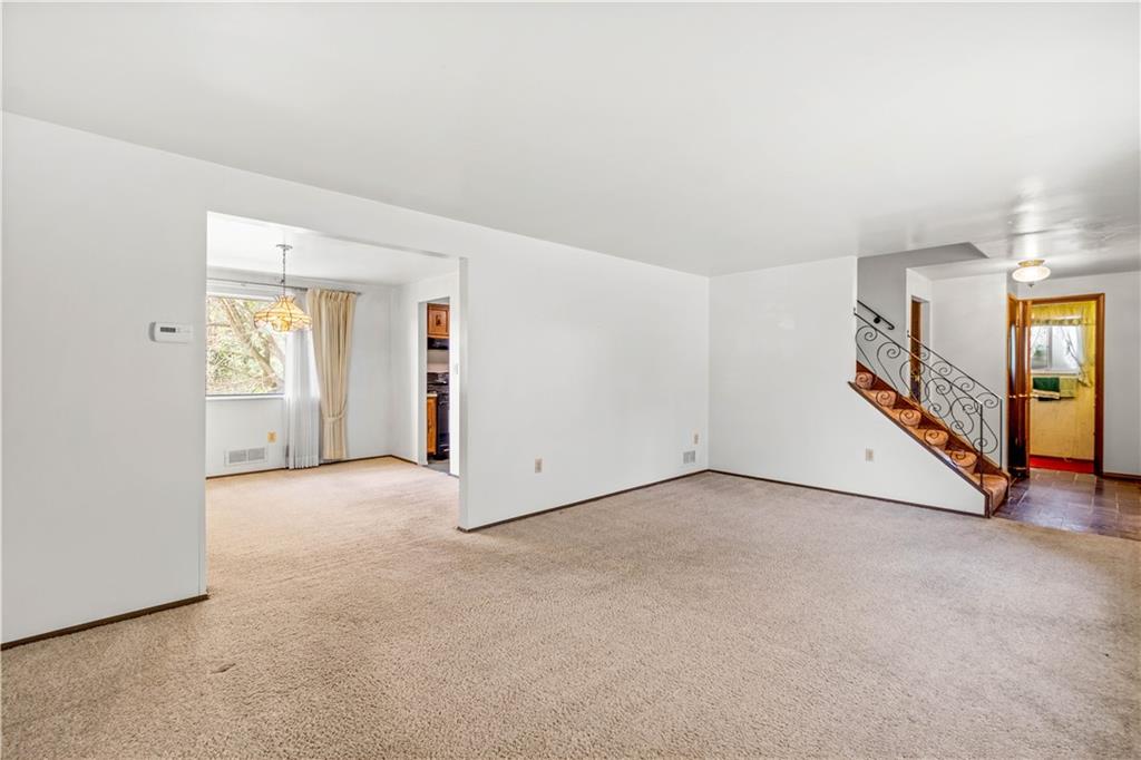 1709 Wilson Road Pittsburgh, PA 15236 - Photo 9 of 25 an empty room with entrance and stairs