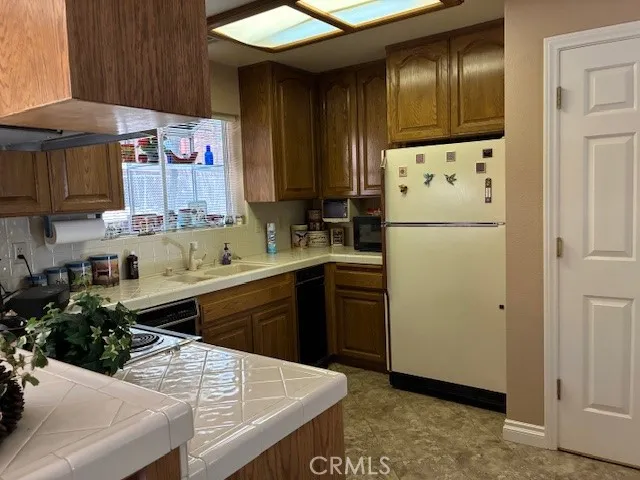a kitchen with a refrigerator and a sink