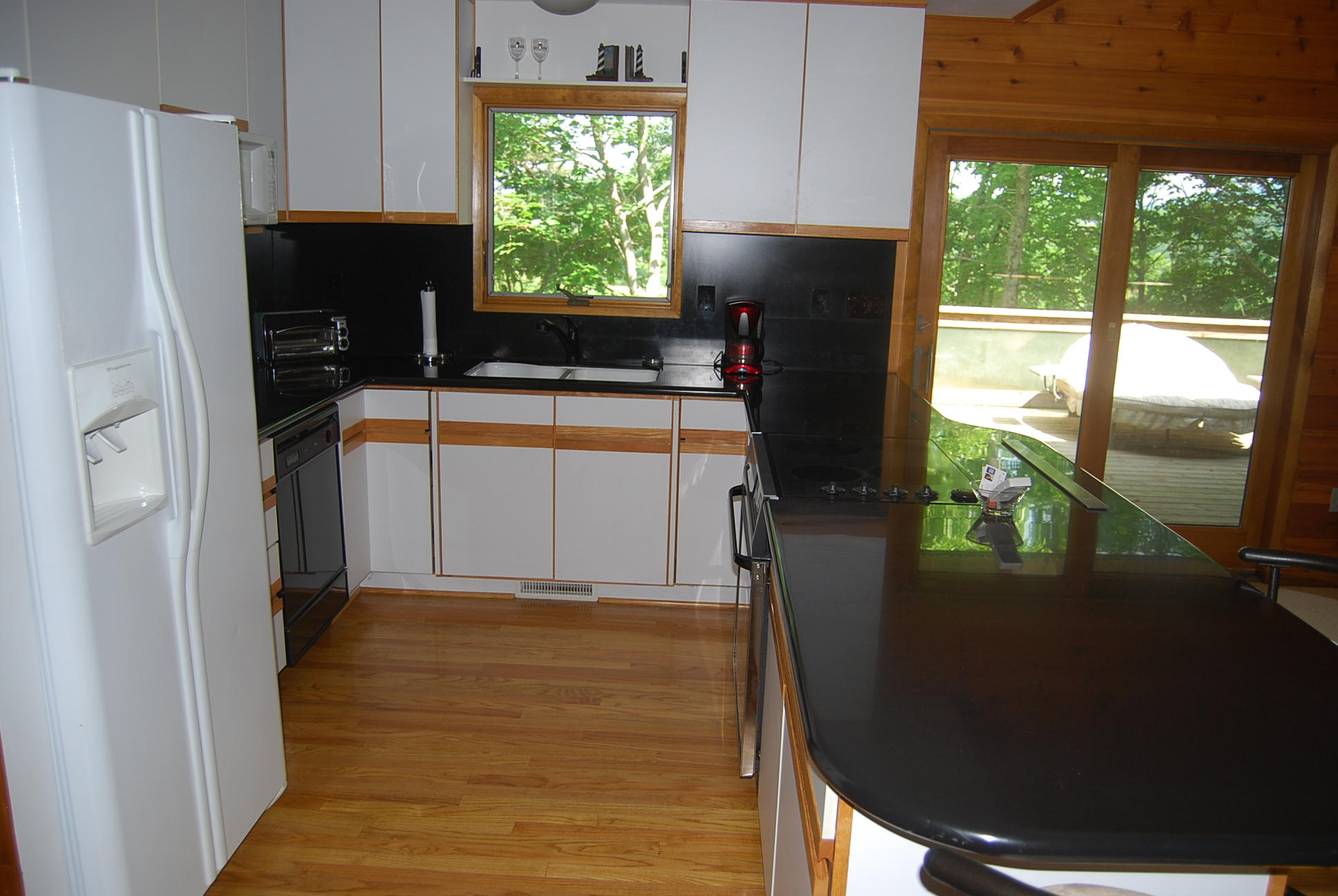 8045 Hardy Road Hardy, VA 24101 - Photo 23 of 63 a kitchen with a window a refrigerator and a stove