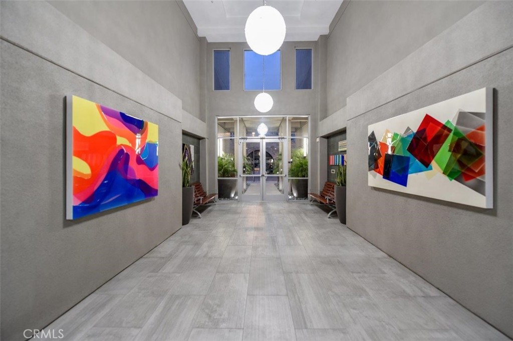 21 Gramercy, Unit 112 Irvine, CA 92612 - Photo 12 of 16 wooden floor with painting on the wall and a large window