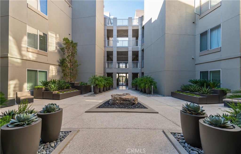 21 Gramercy, Unit 112 Irvine, CA 92612 - Photo 15 of 16 a view of a building with potted plants