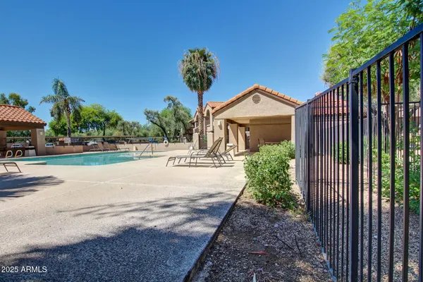 a front view of a house with a yard and fountain in middle