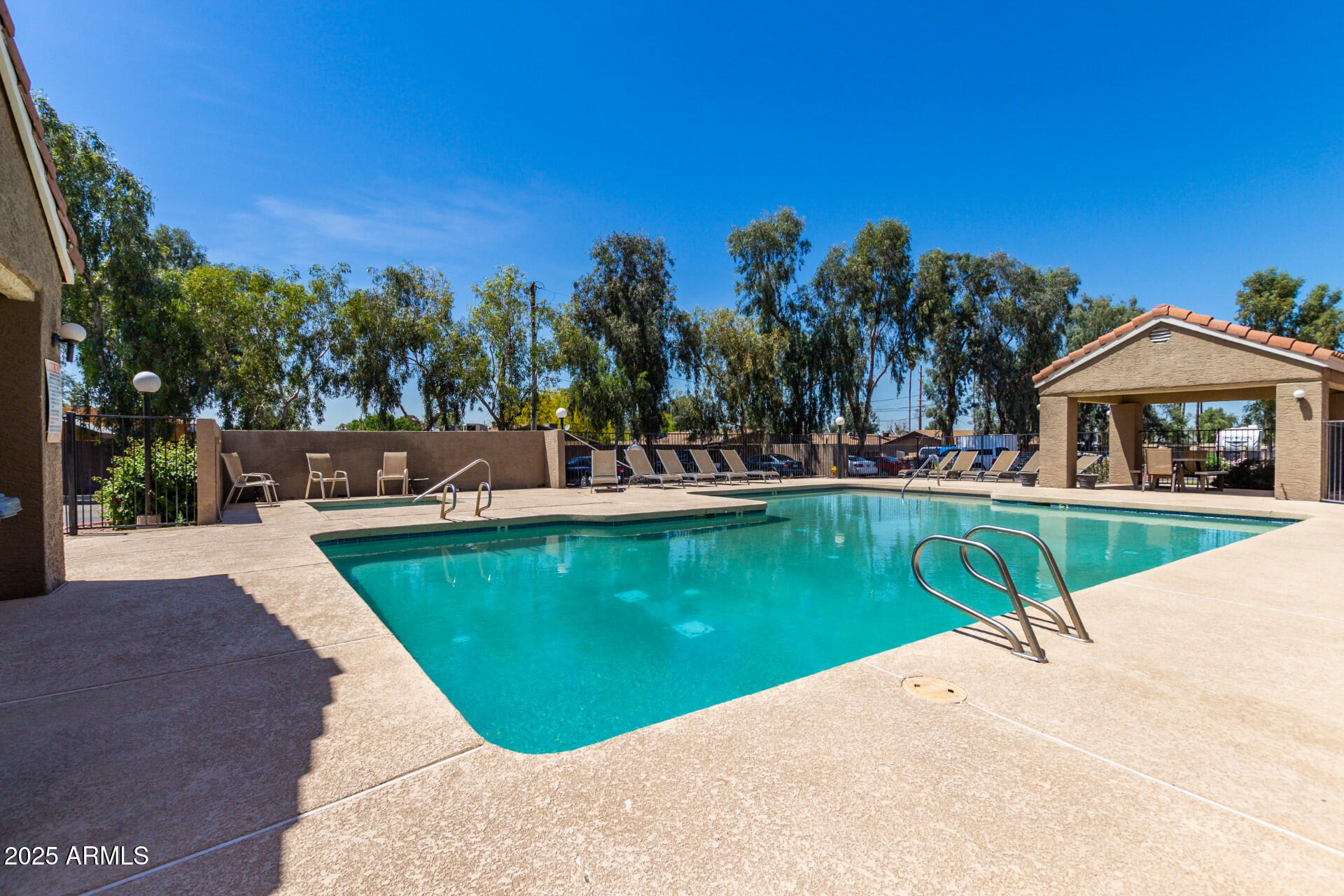 609 East Mesquite Circle, Unit D131 Tempe, AZ 85288 - Photo 35 of 39 a view of swimming pool with outdoor seating and trees in the background