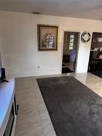 a view of a hallway with paintings on the wall