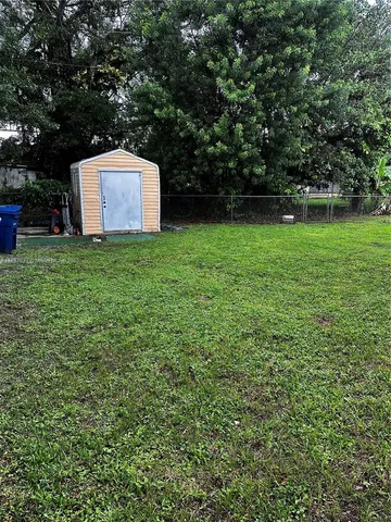 a view of a backyard with a garden and entertaining space