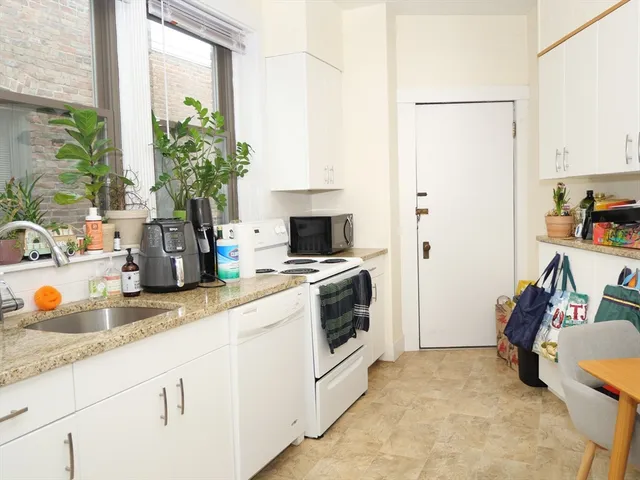 a kitchen with a sink stove and refrigerator