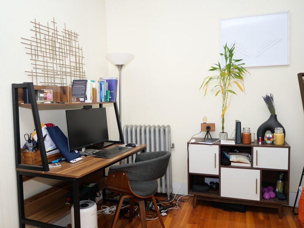1390 Beacon Street, Unit 12 Brookline, MA 02446 - Photo 3 of 9 a view of a workspace with furniture and a window