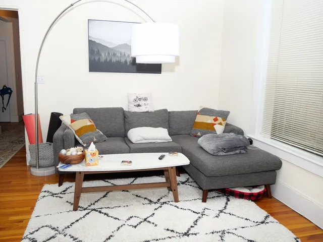 a living room with furniture and a mirror