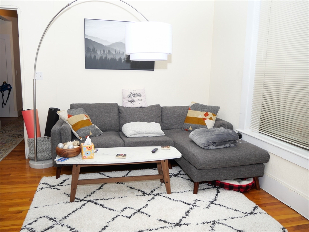 1390 Beacon Street, Unit 12 Brookline, MA 02446 - Photo 4 of 9 a living room with furniture and a mirror