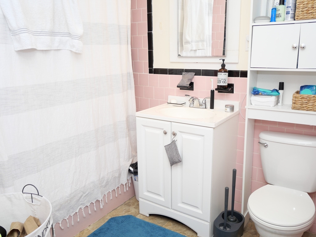 1390 Beacon Street, Unit 12 Brookline, MA 02446 - Photo 6 of 9 a bathroom with a sink a toilet and a bathtub