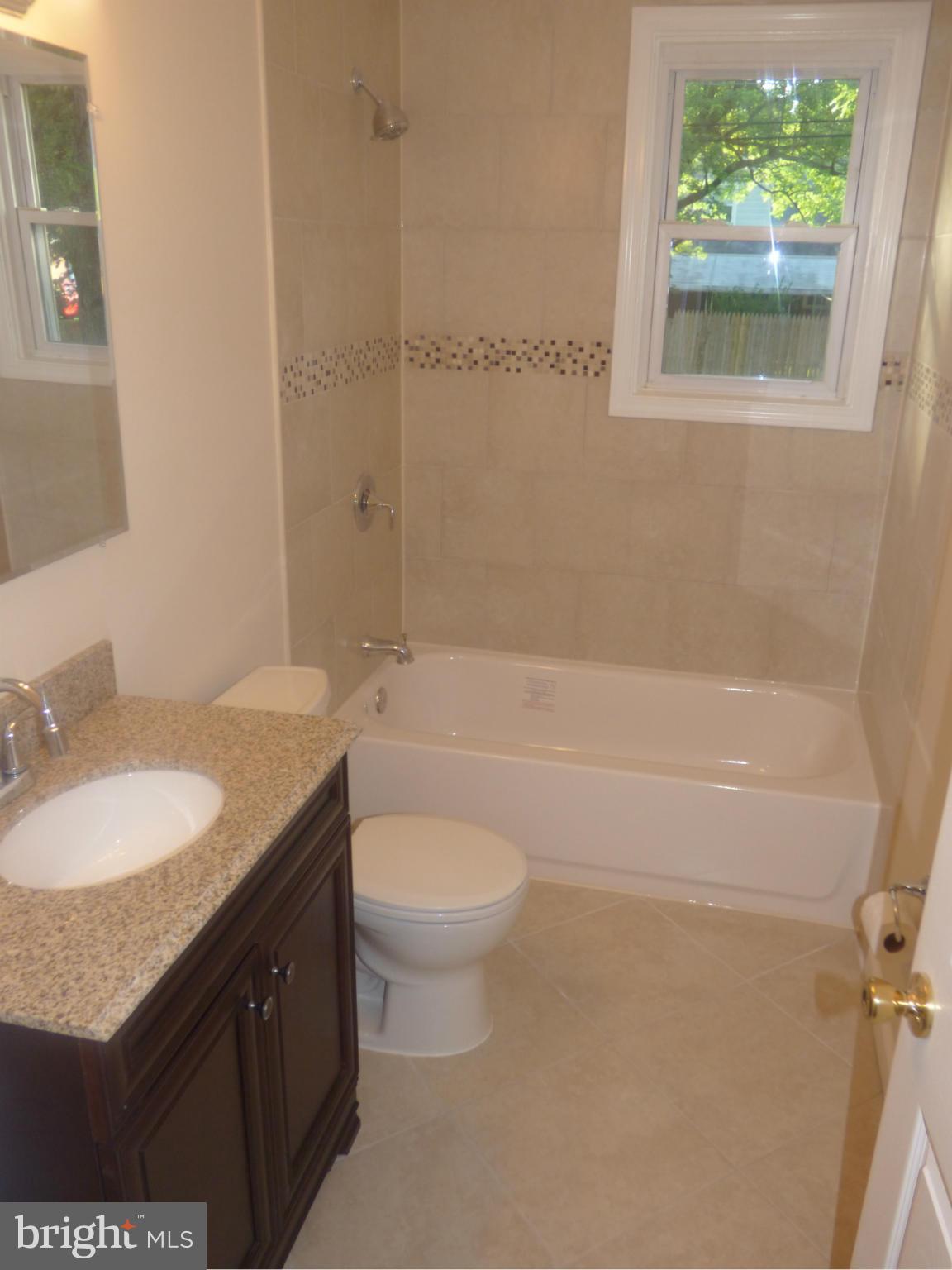 3405 Mayfair Road Baltimore, MD 21207 - Photo 18 of 27 a bathroom with a granite countertop sink toilet and shower