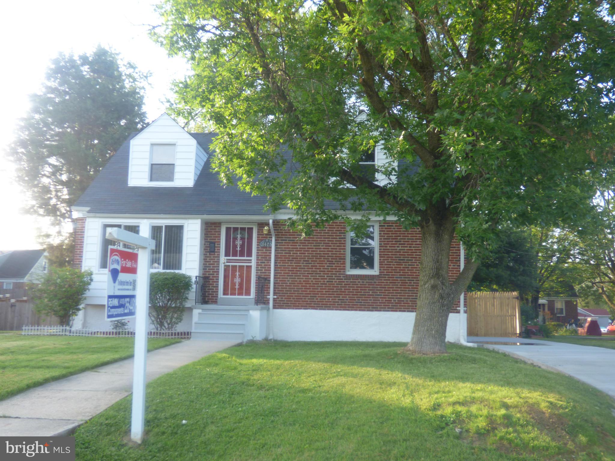 3405 Mayfair Road Baltimore, MD 21207 - Photo 24 of 27 a front view of a house with a yard and garage
