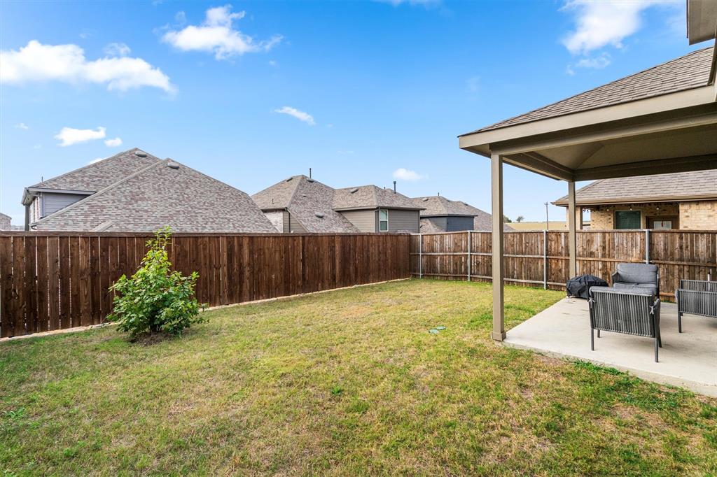 2407 Neff Lane Forney, TX 75126 - Photo 21 of 22 a view of a backyard with a garden and plants