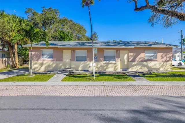 a view of a house with a yard and a ocean view